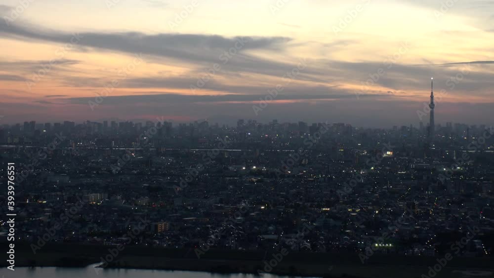 TOKYO, JAPAN : Aerial high angle sunrise CITYSCAPE of TOKYO. View of rising sun and buildings at central downtown area. Japanese city life and nature concept. Time lapse shot night to morning. TOKYO, JAPAN : Aerial high angle sunrise CITYSCAPE of TOKYO. View of rising sun and buildings at central downtown area. Japanese city life and nature concept. Time lapse shot night to morning.
