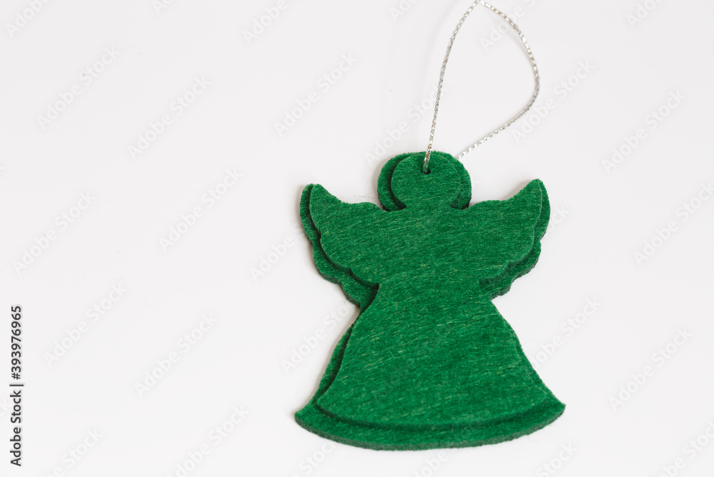 Green angel with a ribbon. Greeting a Christmas Card for xmas & New Year holidays. Christmas holidays background with copy space for your text. Christmas, New year and Holidays concept.