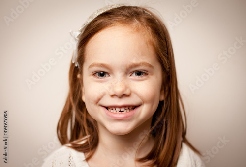 Smiling Little Girl with Red Hair and Missing Tooth, Happy Childhood Portrait
