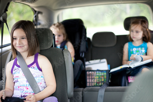 Three Little Girls Sitting in a Minivan photo