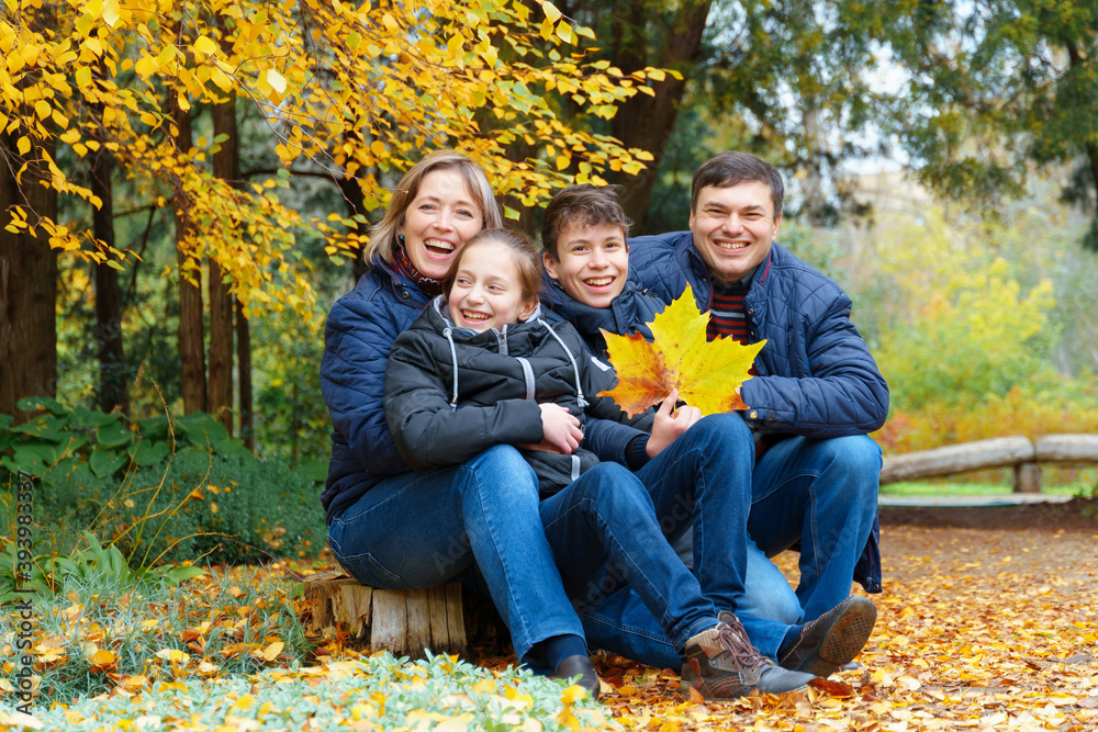 family relaxing outdoor in autumn city park, happy people together, parents and children, they talking and smiling, posing near yellow birch leaves, beautiful nature family relaxing outdoor in autumn city park, happy people together, parents and children, they talking and smiling, posing near yellow birch leaves, beautiful nature