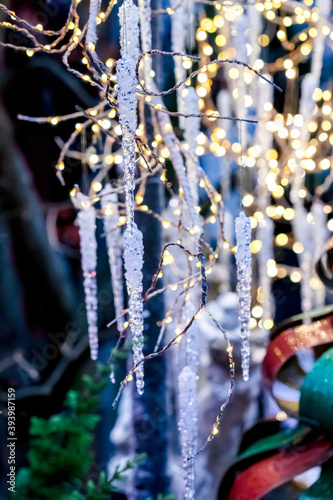 Outdoor Icicles Christmas Decoration and light garlands, blurred background