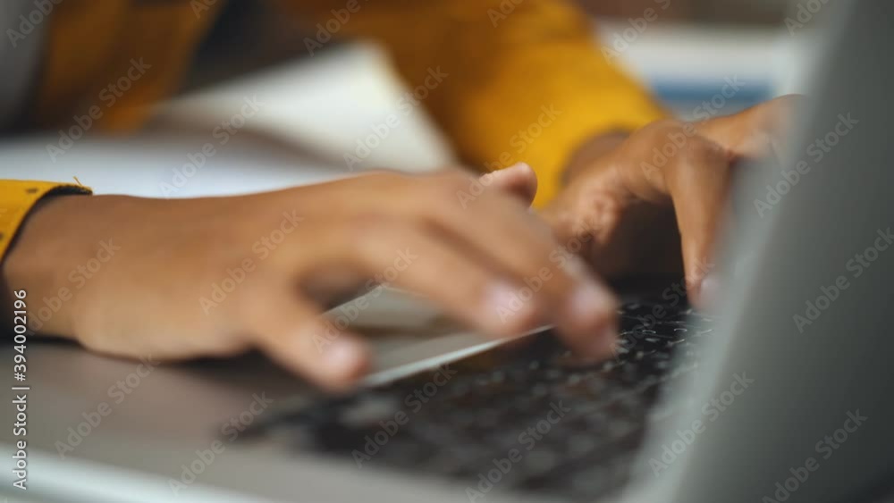 Close up of african child browsing internet on laptop