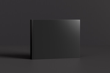 Fototapete Grau 2 Gebundenes horizontales oder querformatiges schwarzes Mockup-Buch, das auf schwarzem Hintergrund steht.  © dimamoroz