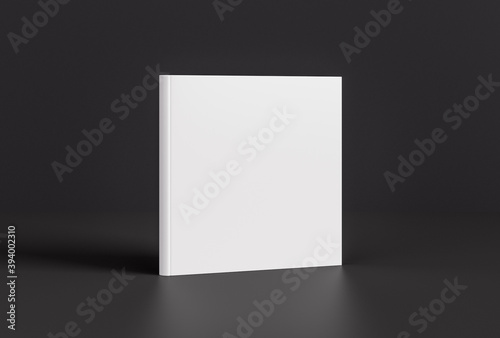 Hardcover square white mockup book standing on the black background.