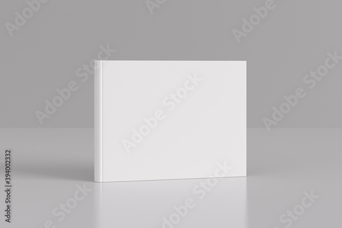 Hardcover horizontal or landscape white mockup book standing on the white background.