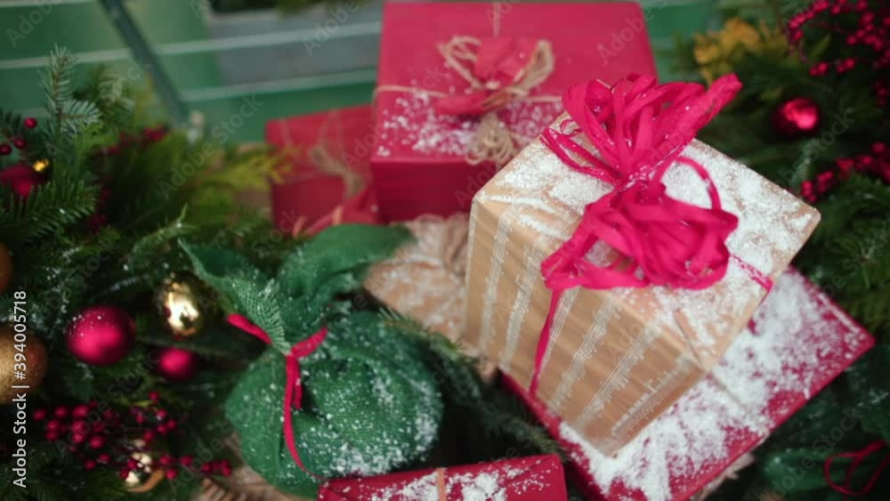 New Year's decorations in the form of boxes and bags with gifts sprinkled with snow, a coniferous branch decorated with colorful balls. The atmosphere of the coming winter Xmas holidays. New Year's decorations in the form of boxes and bags with gifts sprinkled with snow, a coniferous branch decorated with colorful balls. The atmosphere of the coming winter Xmas holidays.