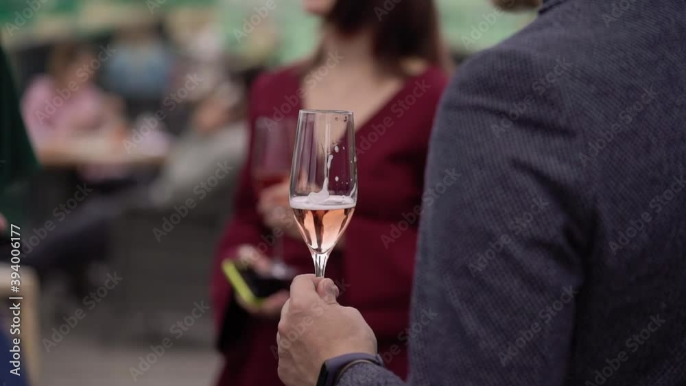 People with glass of champagne at the party. man hold wine drinking at welcome People with glass of champagne at the party. man hold wine drinking at welcome