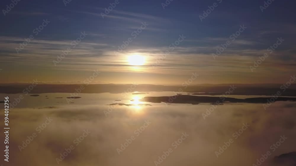 flying on a winter day in the sun above low clouds and the white sea in the distance flying on a winter day in the sun above low clouds and the white sea in the distance