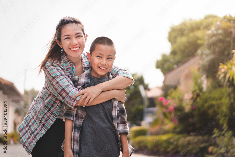 Happy mother hug son or pupil with backpack before they go to school, Back to school concept, Selective focus. Happy mother hug son or pupil with backpack before they go to school, Back to school concept, Selective focus.