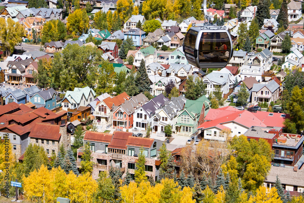 Fototapeta premium Telluride Gondola Car -Autumn aerial view of a Gondola Car with Telluride homes in the San Juan mountains of southwestern Colorado, San Miguel County