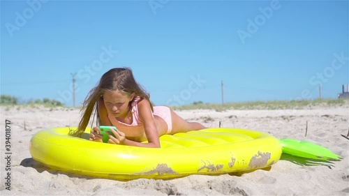 Adorable girl on inflatable air mattress in the sea