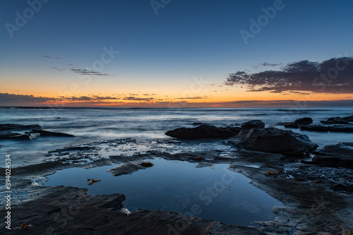 Rocky coastline sunrise seascape © Merrillie