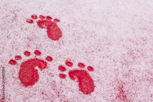 Traces. Drawing of a child in the snow against a red background. Smile. Joy. the texture of the snow,the frozen glass of the car. Place free for text.