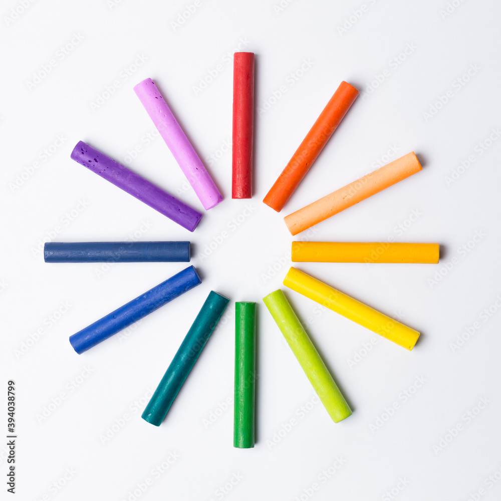 Oil Pastel Crayons on White background. Color Wheel Colors.