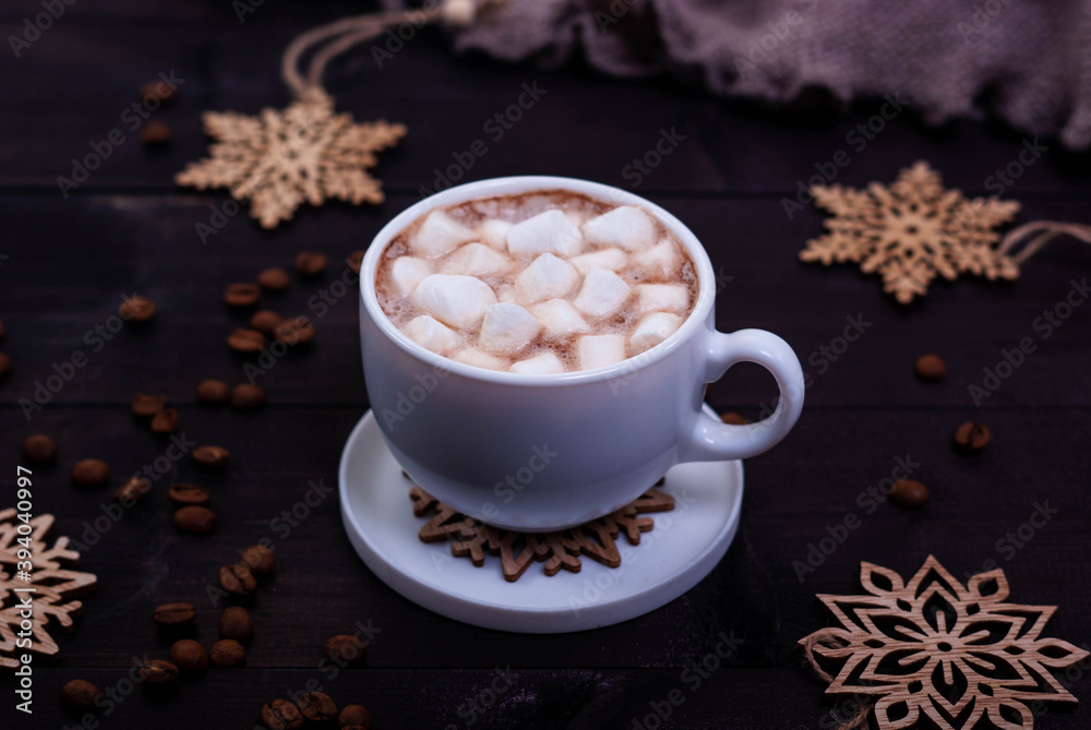 Cup of coffee with marshmallows and wooden snowflakes on dark wooden table. Winter concept, dark mood photo. Cup of coffee with marshmallows and wooden snowflakes on dark wooden table. Winter concept, dark mood photo.