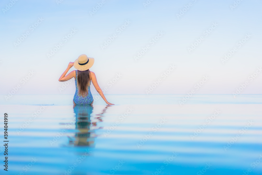Portrait beautiful young asian woman relax smile leisure around outdoor swimming pool nearly sea
