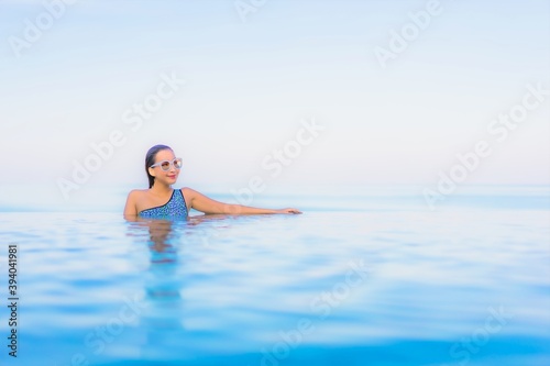 Portrait beautiful young asian woman relax smile leisure around outdoor swimming pool nearly sea
