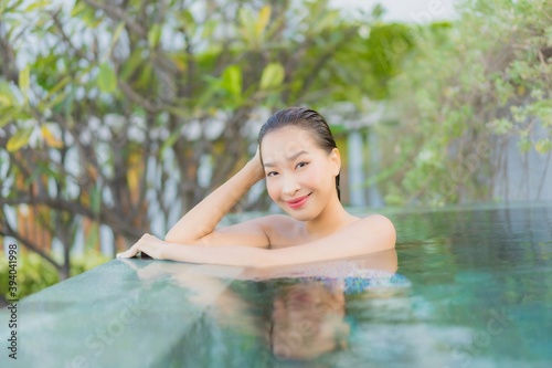 Portrait beautiful young asian woman relax smile leisure around outdoor swimming pool nearly sea © siraphol