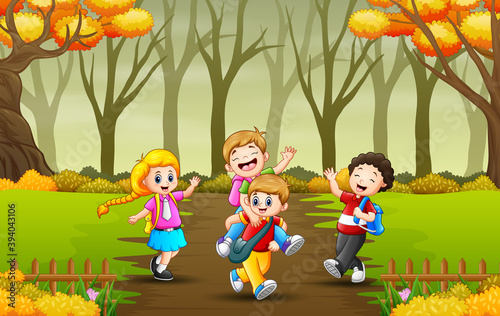 Kids going to school through an autumn forest path