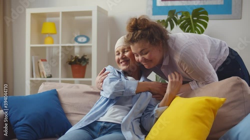 Young woman visiting her mother with cancer indoors