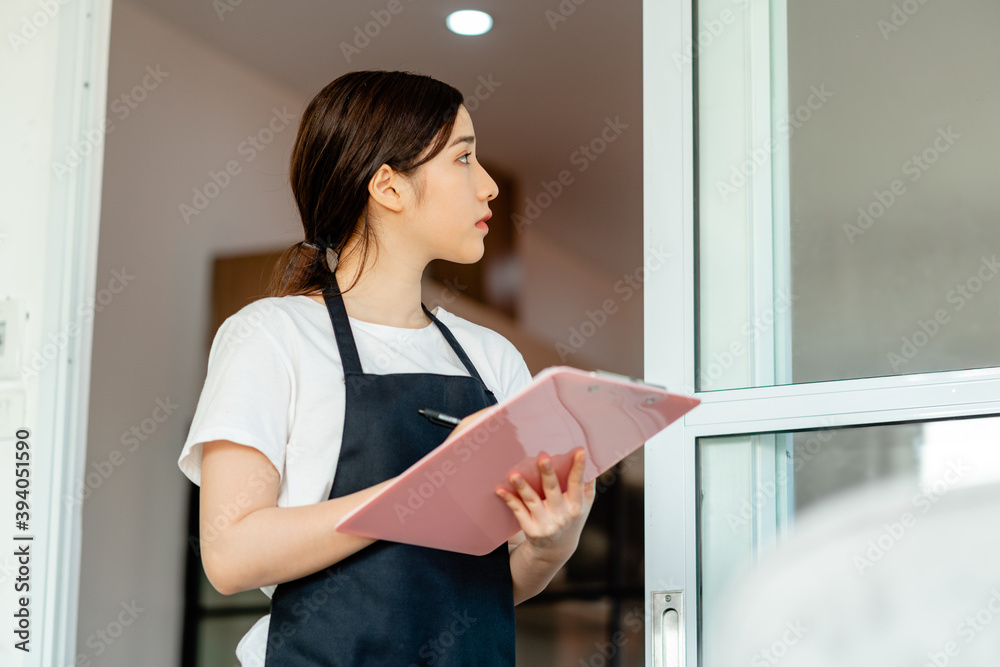 The Asian waitress is checking the hotel room after guests check out The Asian waitress is checking the hotel room after guests check out
