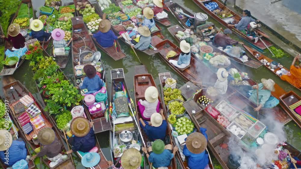 Damnoen Saduak Floating Market or Amphawa. Local people sell fruits, traditional food on boats in canal, Ratchaburi District, Thailand. Famous Asian tourist attraction destination. Festival in Asia.