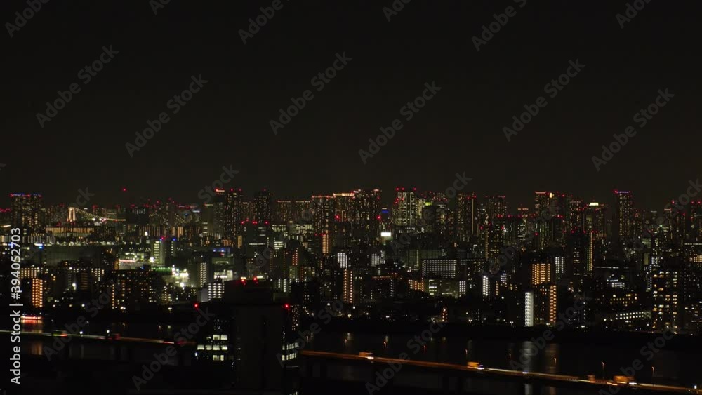 TOKYO, JAPAN : Aerial high angle view of CITYSCAPE of TOKYO at night time. View of busy central downtown area. Japanese urban metropolis and nightlife concept. Wide time lapse tracking shot. TOKYO, JAPAN : Aerial high angle view of CITYSCAPE of TOKYO at night time. View of busy central downtown area. Japanese urban metropolis and nightlife concept. Wide time lapse tracking shot.