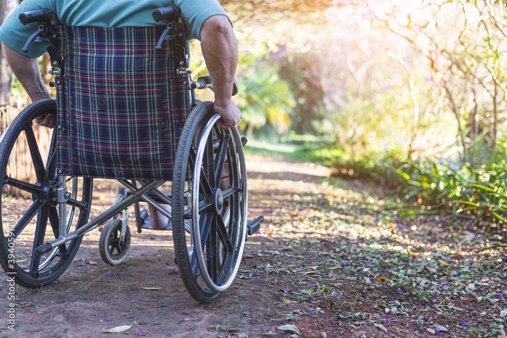 Obraz premium disabled male in a wheelchair in a garden