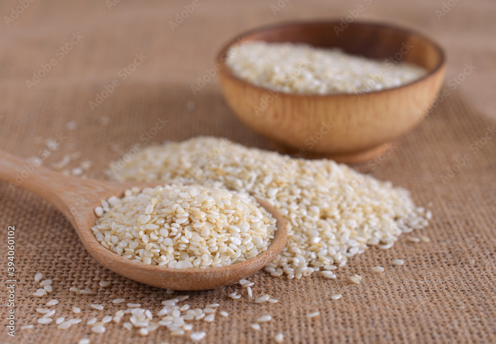 White sesame in a wooden spoon,copy space. White sesame in a wooden spoon,copy space.