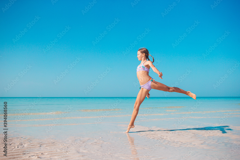 Adorable active little girl at beach during summer vacation Adorable active little girl at beach during summer vacation