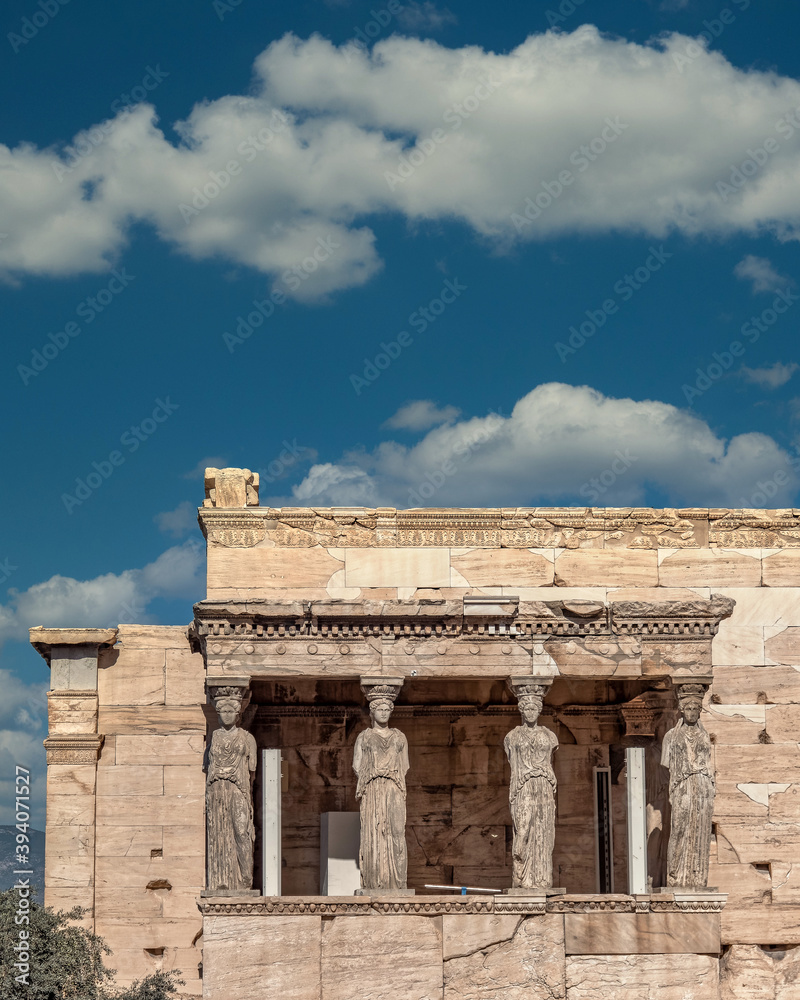 Athens Greece, scenic view of Caryatides statues on Erechtheion ancient temple facade under dramatic sky, filtered image