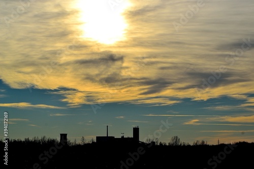 afternoon autumn sunset over the mining tower of a coal mine on the horizon of the industrial landscape, Karvina, Czech Republic