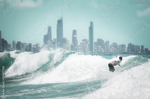 Surfing with the skyline of the Gold Coast in the background