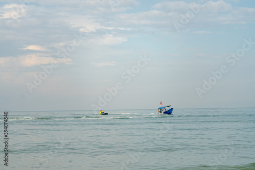 People having fun on water craft at Port Dickson. © ellinnur