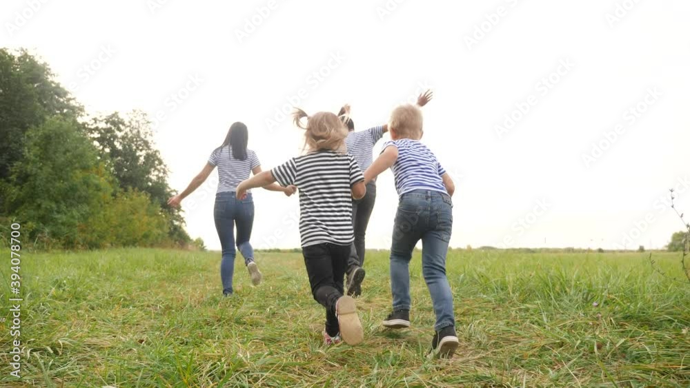 happy family children kid together run in the park at sunset silhouette. people in park concept mom dad daughter and son joyful run. happy family and little baby child summer fun kid dream concept happy family children kid together run in the park at sunset silhouette. people in park concept mom dad daughter and son joyful run. happy family and little baby child summer fun kid dream concept