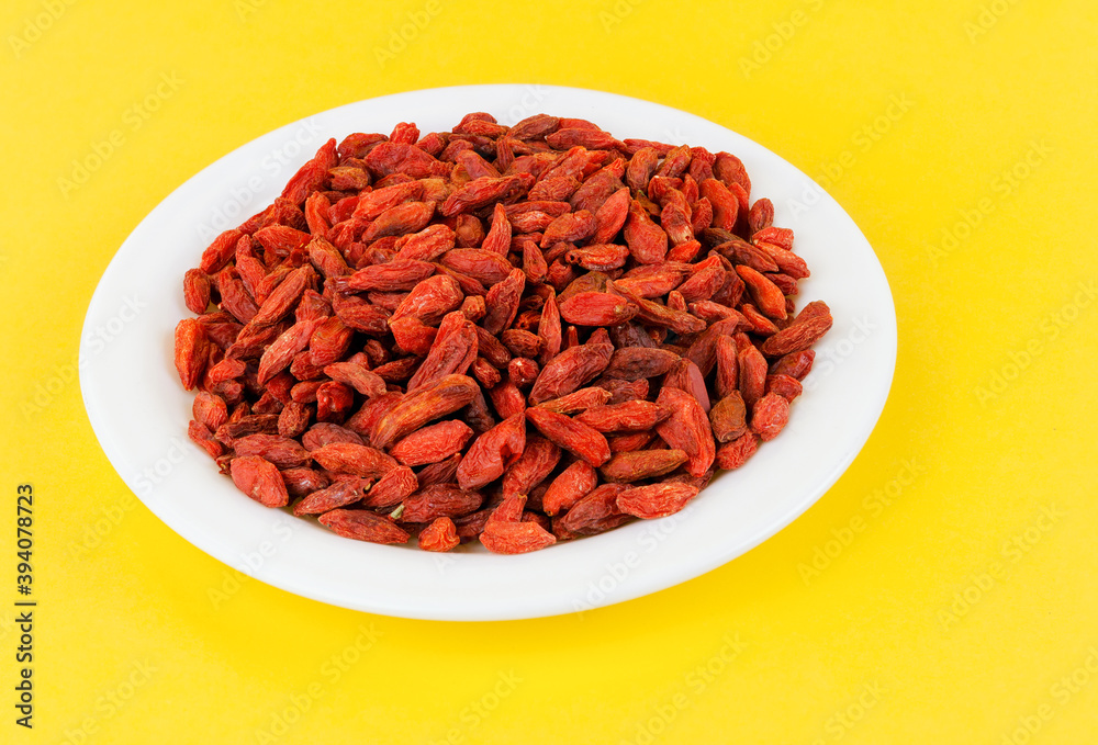 Dried goji berries in a white plate Dried goji berries in a white plate