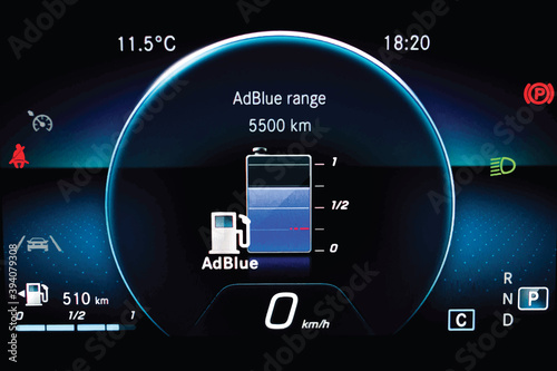 Illustration of AdBlue level indicator on illuminated car dashboard. Car instrument panel with speedometer, fuel gauge, seat belt reminder Urea level display on car cluster. Check diesel exhaust fluid