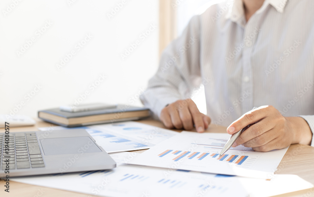 Business men analyze graphs of financial accounts in private office. Business men analyze graphs of financial accounts in private office.