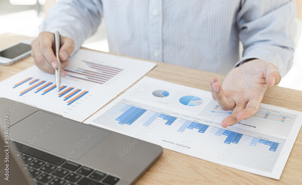 Business men press the calculator to calculate company expenses in the room. Business men press the calculator to calculate company expenses in the room.