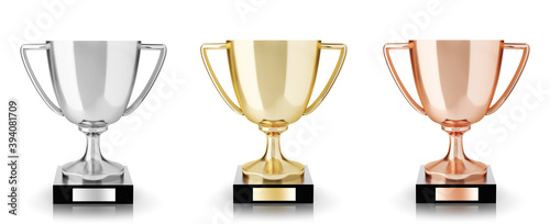Golden, silver and bronze trophies isolated on white background. 