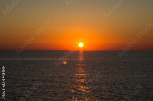 evocative image of sunrise over the sea with the sun rising on the horizon © massimo