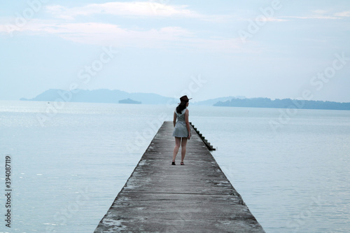 woman on bridge during sunset