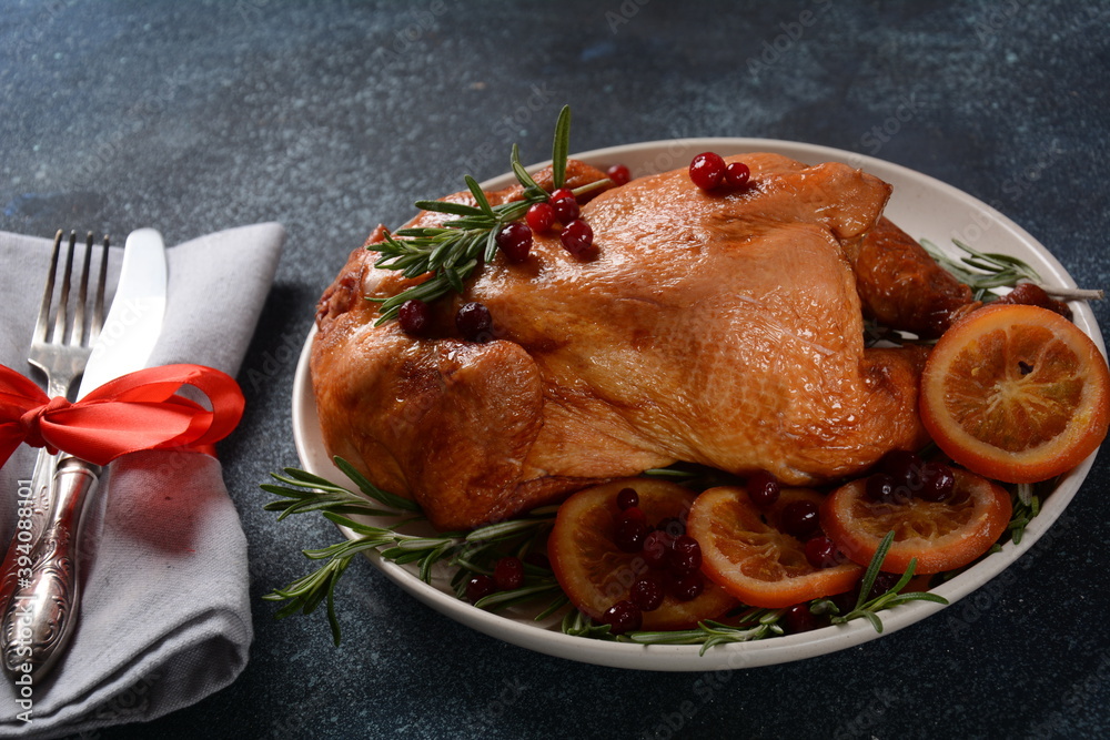Roasted/baked whole chicken with spices, orange and herbs. Christmas food concept. Roasted/baked whole chicken with spices, orange and herbs. Christmas food concept.