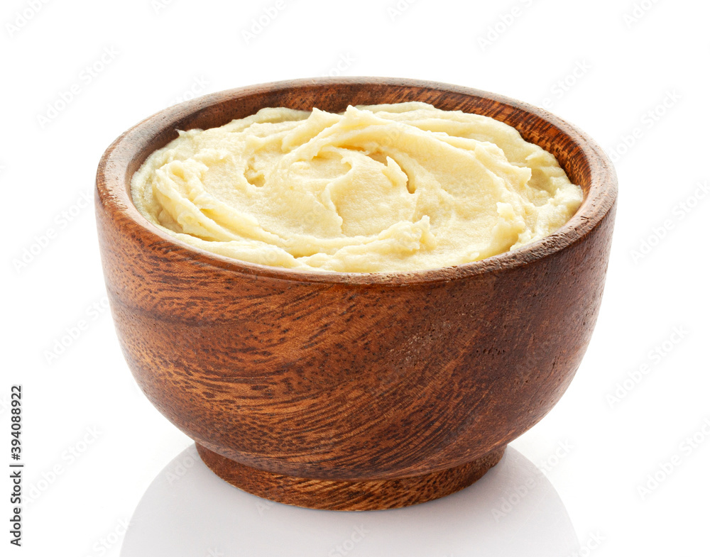 Mashed potato puree in wooden bowl isolated on white background Mashed potato puree in wooden bowl isolated on white background