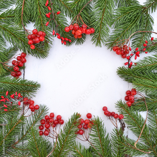 New Year and Christmas border design. White wooden background with fir tree. Top view with copy space.