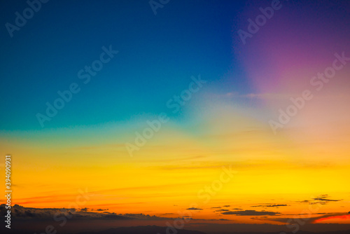 Colorful cumulus sunset sky clouds with sun setting down
