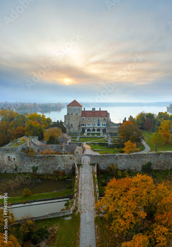Castle of Tata city in Hungary. Amazing water fort next to Old lake. Built in 13th century. Beautiful dramatic sunrise view.