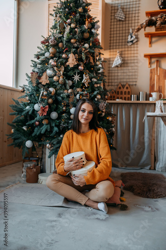 Christmas decorations. Happy young woman under the christmas tree with gifts. Making wishes under the Christmas tree. © Маргарита Щипкова