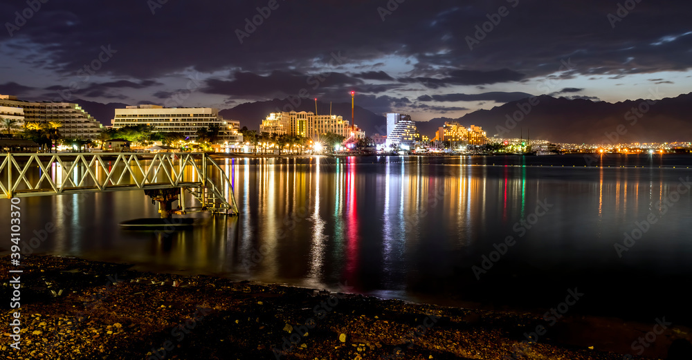 Nocturnal view on the Red Sea from central public beach of Eilat - famous resort and recreational city of Israel